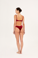Red bandeau bikini top by Aguaclara featuring a sleek, strapless design with smooth fabric and a vibrant red color.