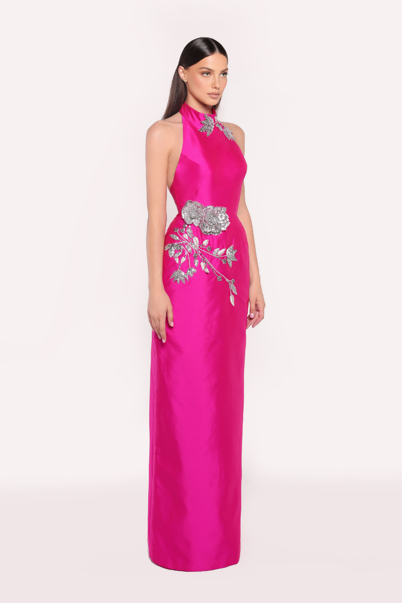Elegant fuchsia ROVENA gown by Tarık Ediz featuring flowing fabric and intricate detailing, perfect for formal occasions.