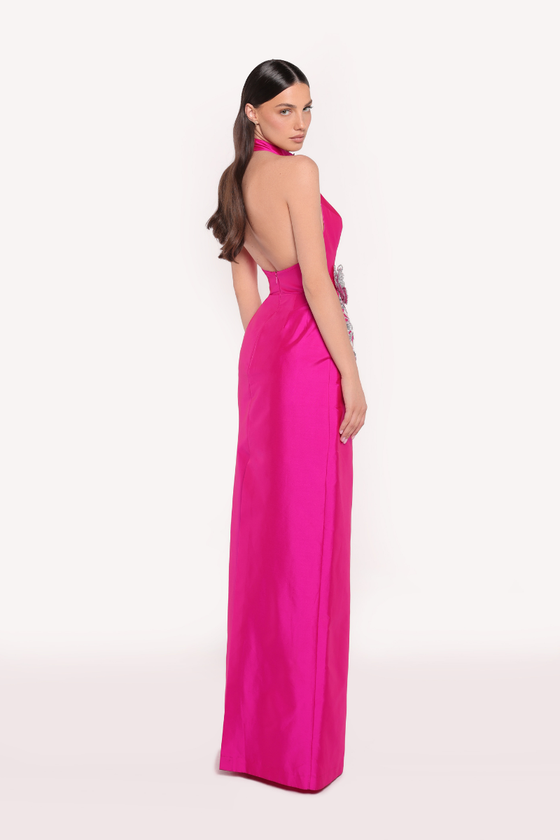 Elegant fuchsia ROVENA gown by Tarık Ediz featuring flowing fabric and intricate details, perfect for formal occasions.