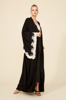 Anastasia long black kimono robe by Bocan Couture with gold lace details, flowing fabric, and elegant design.