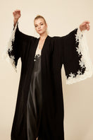 Anastasia long black robe with gold lace trim from Bocan Couture, featuring flowing fabric and elegant design.