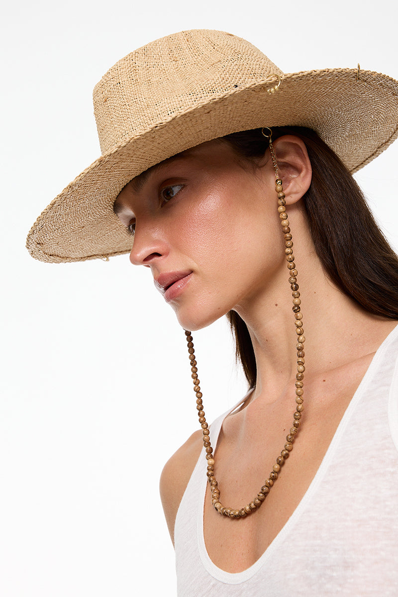 Beige raffia fedora hat by LE SH KA, featuring a wide brim and woven texture, perfect for stylish sun protection.