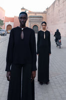 Black Ramila maxi dress by Baobab, flowing fabric, sleeveless design, and elegant length perfect for casual or formal wear.