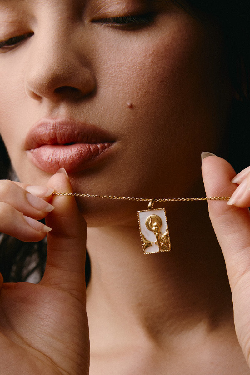 Gold vermeil rectangle woman and moon necklace by Freya Rose, featuring a sleek rectangular pendant and moon charm.