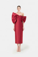 Red Montsand gown with a large bow detail, elegant evening dress styled for formal occasions.