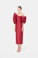 Red gown by Montsand featuring a large bow on the dress, elegant and suitable for formal occasions.
