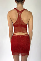 Back view of Natalia Fedner's red chain mini skirt with slip, showcasing a fitted mini skirt with metallic chain details.