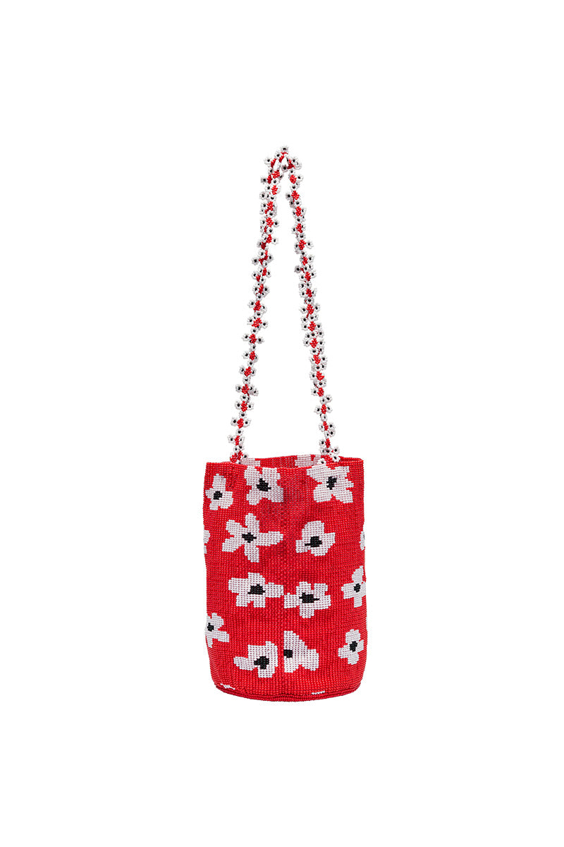 Red flower design on Pura Utz shoulder bag, featuring a vibrant, stylish accessory with floral embroidery and adjustable strap.