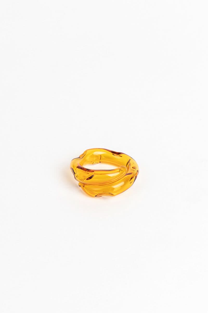 Salvária Remolino rings set with pink, amber, and white rings featuring swirling designs on a white background.