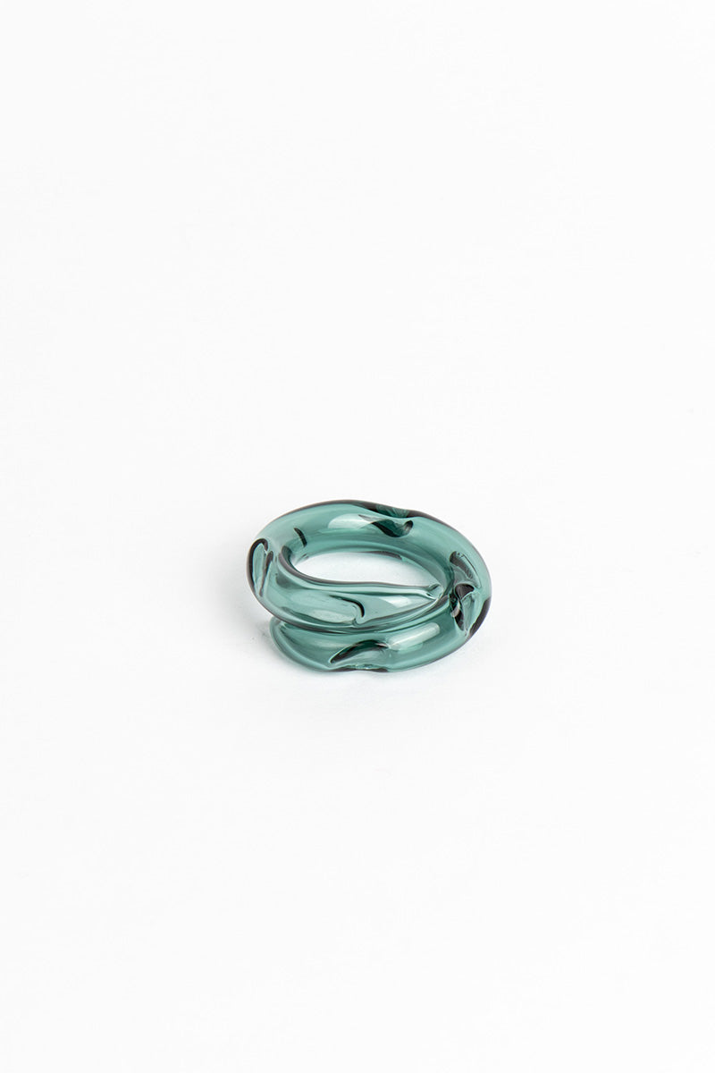 Set of SALVÁREA Remolino rings featuring turquoise, green, and ocean blue colors with swirling designs, displayed together.