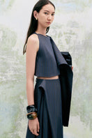 Light beige PANSY cropped sleeveless linen top by LECIA, featuring a relaxed fit and floral design, shown on a model.