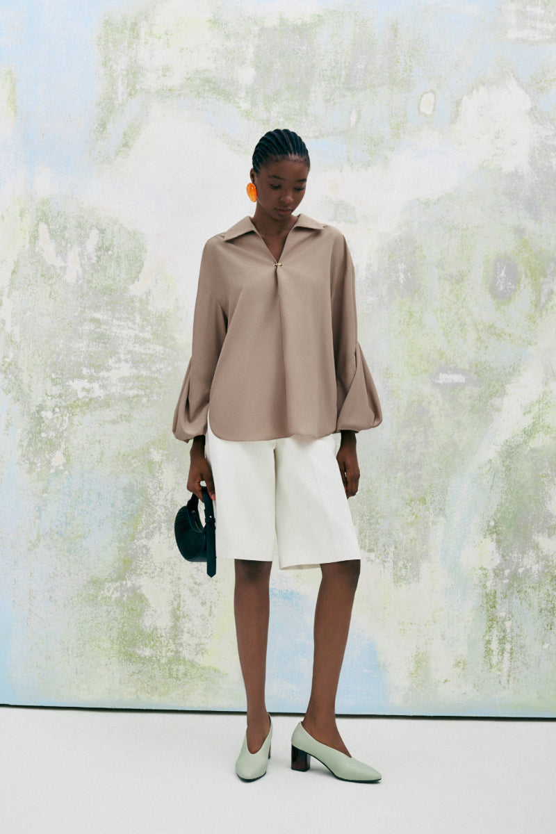 Beige chamomile straight-collared poplin high-low shirt by Lecia, shown with front view highlighting collar and hem details.