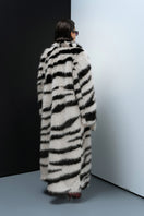 Nana Gotti Chelsea Cool Coat displayed on a hanger, showcasing its stylish design and fabric texture.