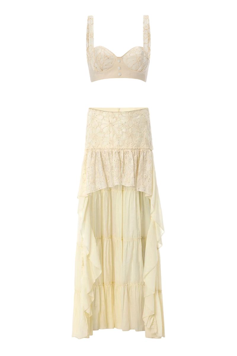 IKINITA Helen butter yellow midi skirt displayed on a hanger, showcasing its flowy fabric and stylish design.