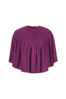 Hand-smocked aubergine cape top by Mastani, showing detailed fabric texture and stylish design on a neutral background.