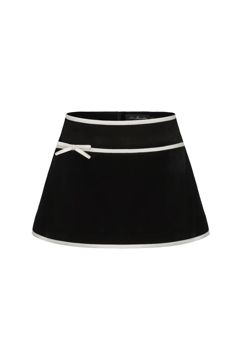 Black Victoria velvet mini skirt by Nana Jacqueline, shown on a model with a fitted waist and soft velvet texture.