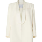 Studio NK ivory blazer from the ETHERAL collection displayed on a hanger, showcasing tailored fit and sleek design.