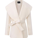 White Victoria Bow Coat by Nana Jacqueline displayed on a hanger, showcasing the elegant design and bow details of the stylish coat.
