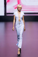 Blue deep plunge maxi gown by CEM featuring a brooch detail, flowing fabric, and elegant design for formal occasions.