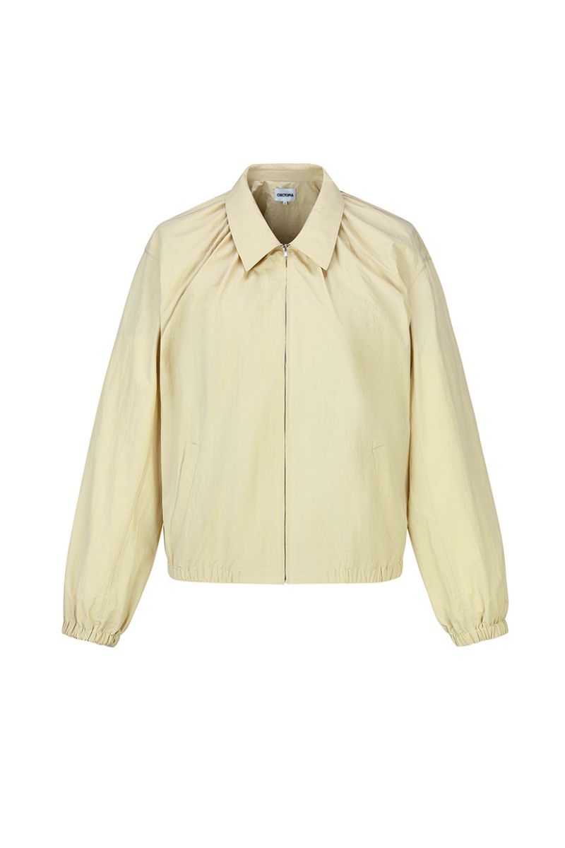 Beige cotton bomber jacket by Chictopia featuring a classic fit, ribbed collar, and zip closure, shown on a model.