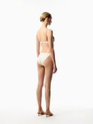 Maliluha Reve bikini set in ivory, front and back view showing stylish bikini top and bottom with minimal coverage.