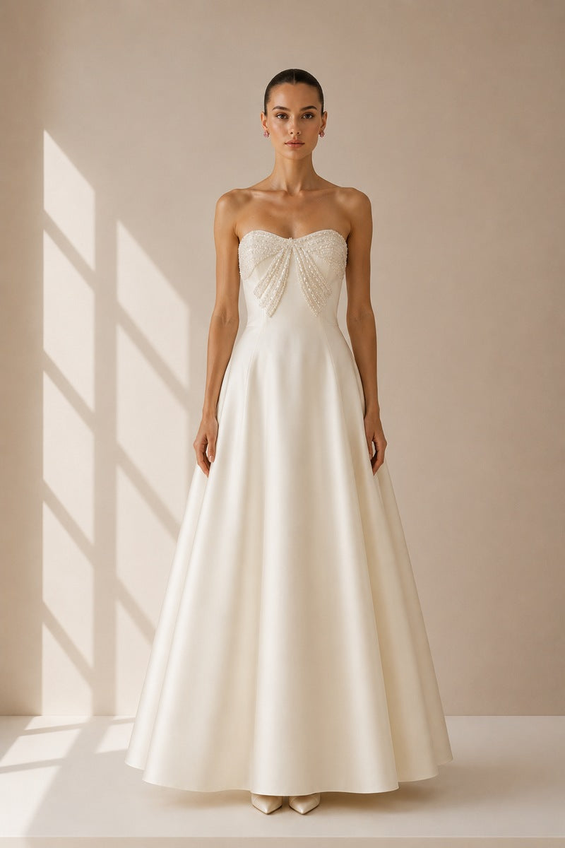 Nihan Peker vanilla ribbon gown featuring a flowing fabric and elegant design, perfect for formal occasions.