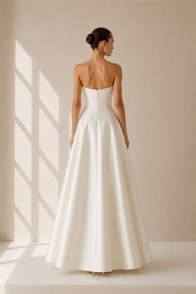 Nihan Peker vanilla ribbon dress gown with elegant fabric and flowing design, displayed on a mannequin.