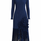 Navy midi dress by Maylé Vásquez featuring a flowing silhouette and elegant design, displayed on a dress form.
