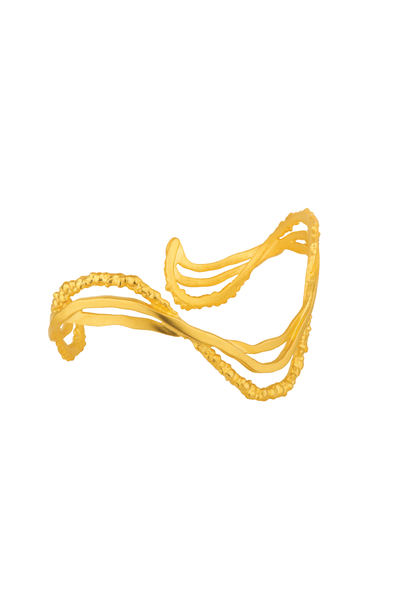 Gold ripple bracelet by Jude Benhalim featuring a textured, flowing design on a sleek jewelry piece.