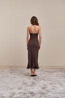 Back view of YASSMIN SALEH Ripple Brown midi dress showcasing its flowing fabric and stylish design.
