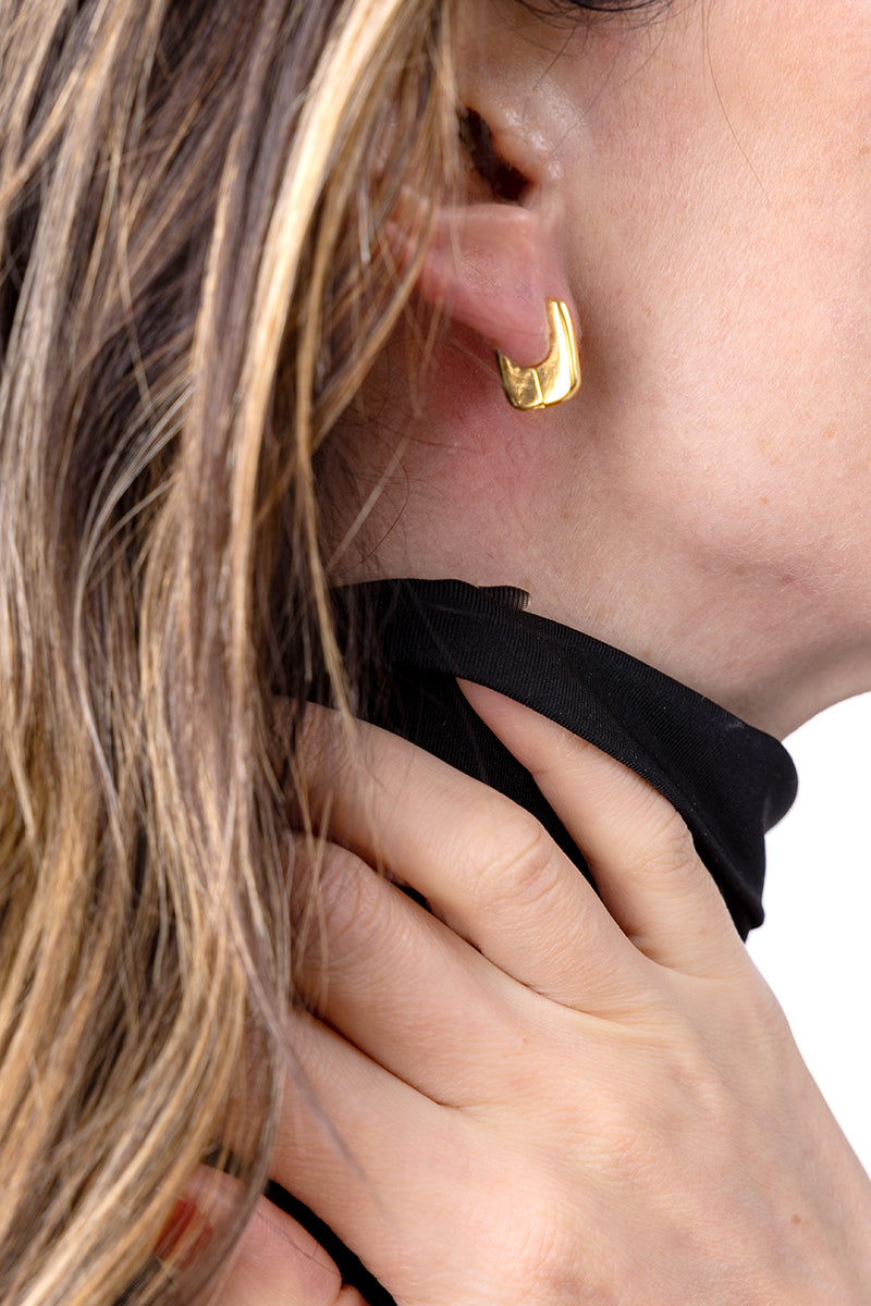 Gold Rita earrings by Sara Shala featuring vibrant yellow color and elegant design, displayed on a model shot.