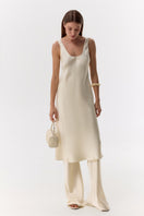 Cream silk-satin bias-cut slim pants by Serenity, featuring a smooth, flowing fit and elegant design.