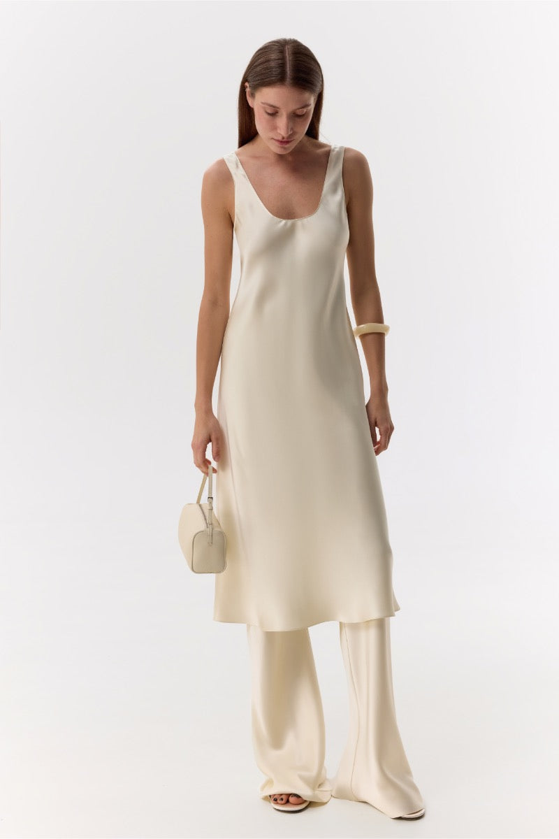 Cream silk-satin bias-cut slim pants by Serenity, featuring a smooth, flowing fit and elegant design.