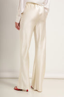 Cream silk-satin bias-cut slim pants by Serenity, featuring a smooth, elegant fit and stylish design.