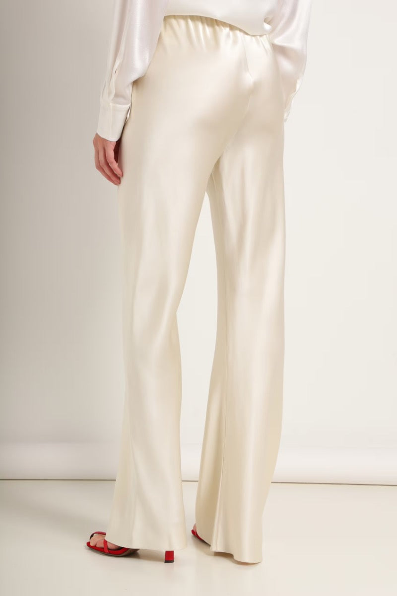 Cream silk-satin bias-cut slim pants by Serenity, featuring a smooth, elegant fit and stylish design.
