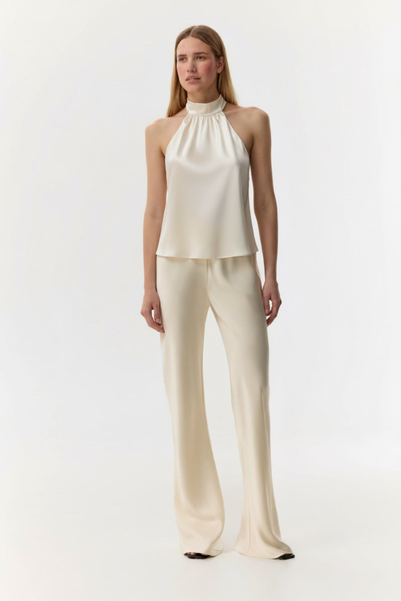 Cream silk-satin bias-cut slim pants by Serenity, featuring a smooth, glossy fabric and elegant tailored fit.