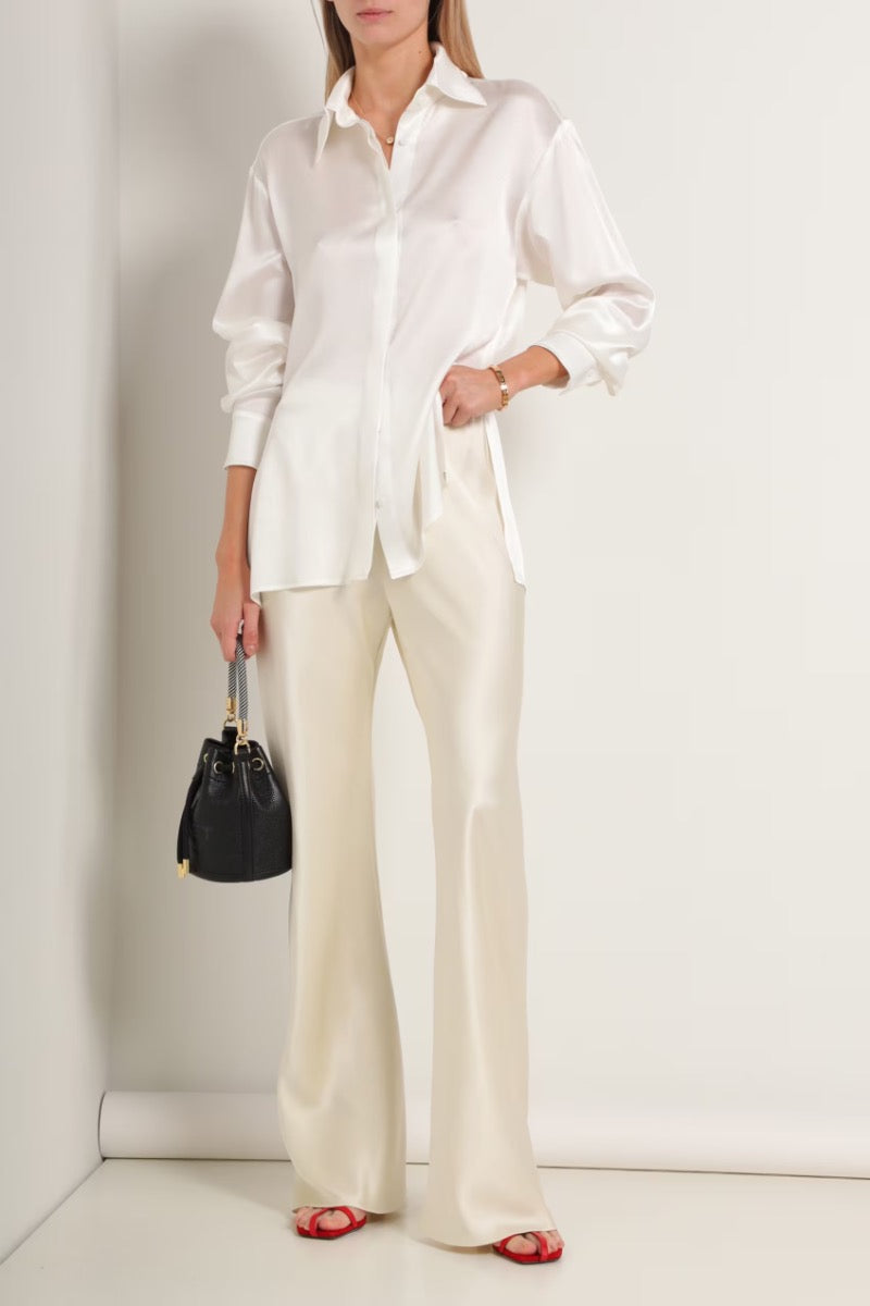Cream silk-satin bias-cut slim pants by Serenity with a smooth, flowing fit and elegant design.