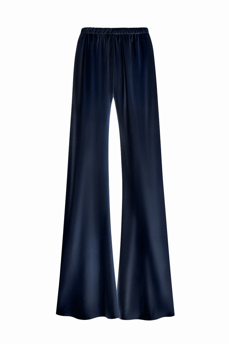 Serenity Riviera navy silk-satin bias-cut slim pants displayed on a model, showcasing elegant, smooth fabric and tailored fit.