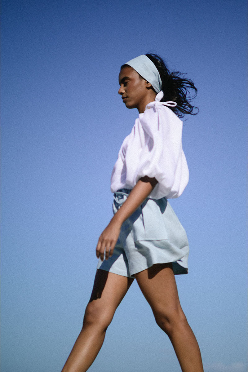 White Rohe cropped top by ANA + MARIA, stylish summer tops, close-up of the fitted, sleeveless design with clean fabric.