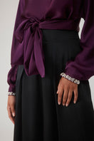 Beaded cuff top in aubergine by Mastani, featuring intricate beadwork and a stylish design, worn as a fashionable women's top.