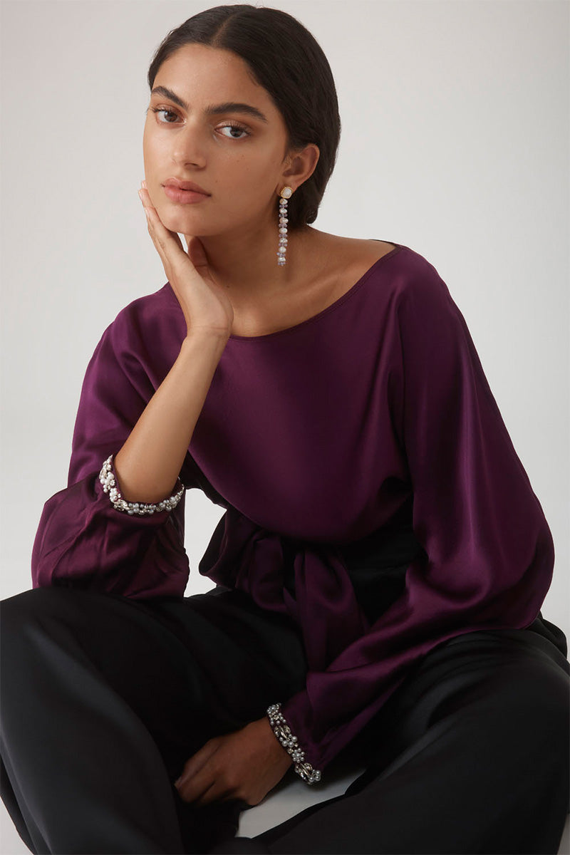 Beaded cuff top in aubergine by Mastani, featuring intricate bead details and a stylish, fitted design.