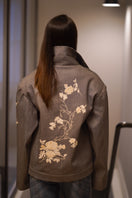 Nadya Shah Rosalind Gray Denim Jacket shown from the back, featuring classic denim design with silver button accents.