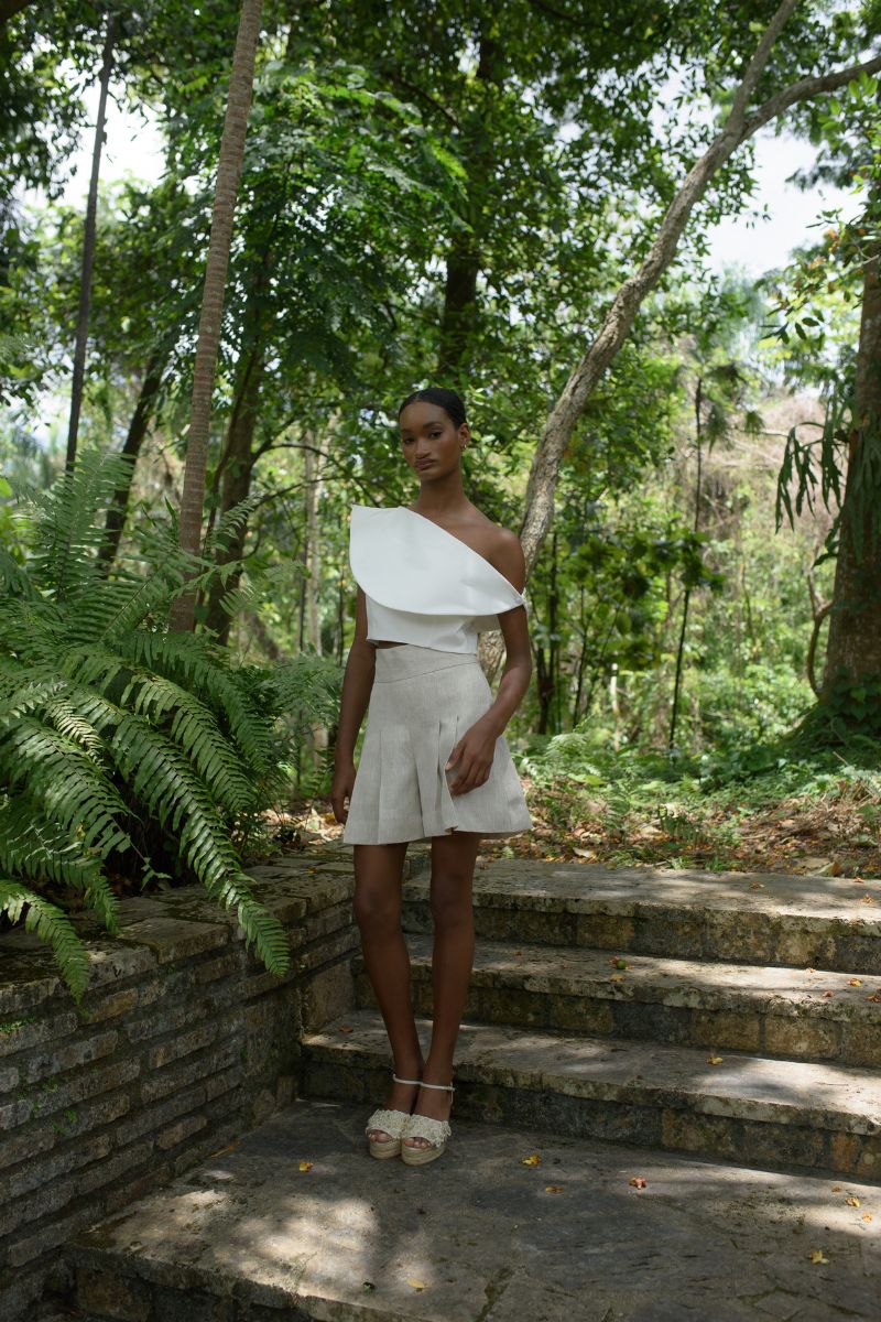 Ivory ROSAVE crop top by ANA + MARIA displayed on a model, highlighting its fitted design and soft fabric.