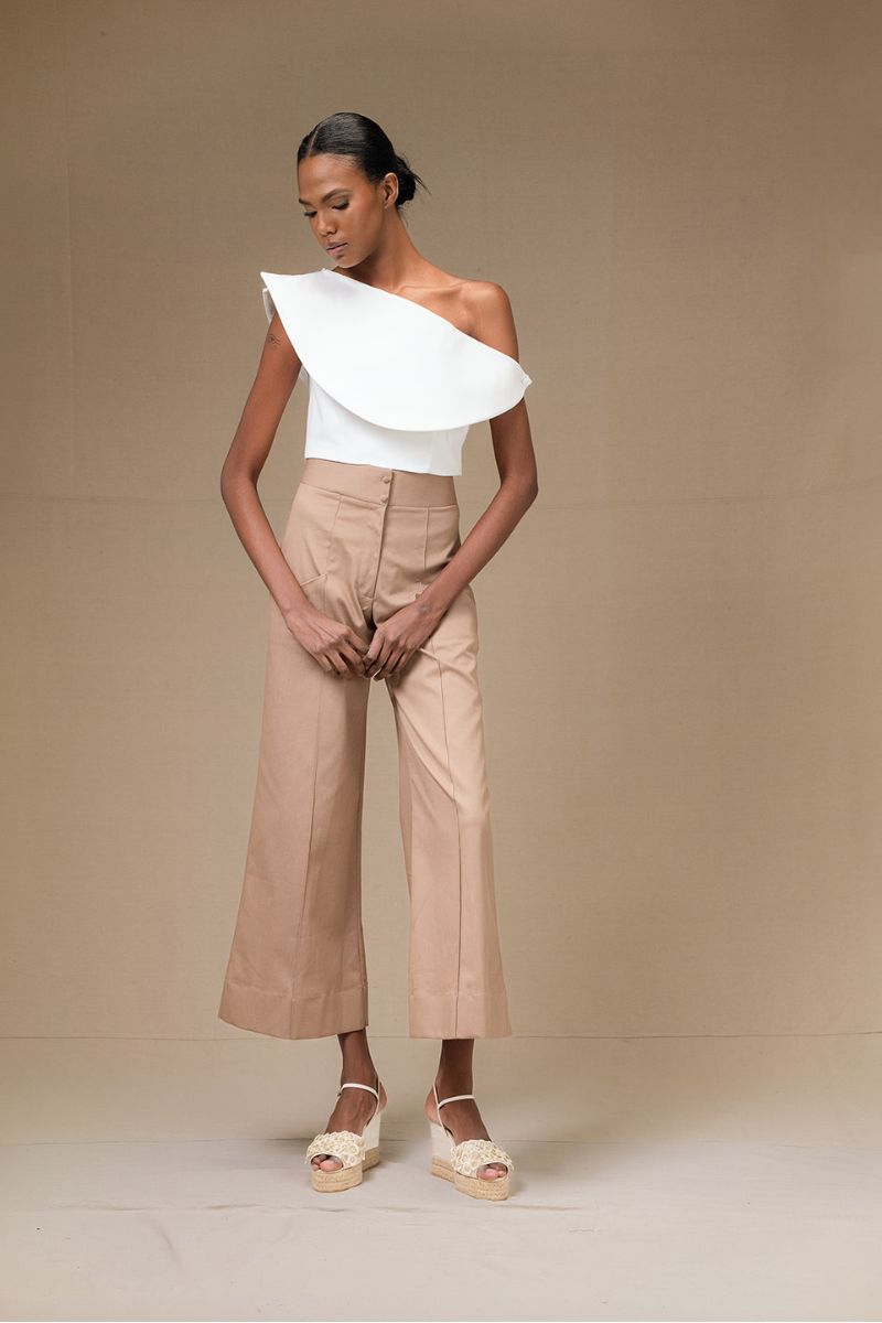 Ivory ROSAVE crop top by ANA + MARIA, showcasing a fitted sleeveless design with a round neckline and soft fabric.