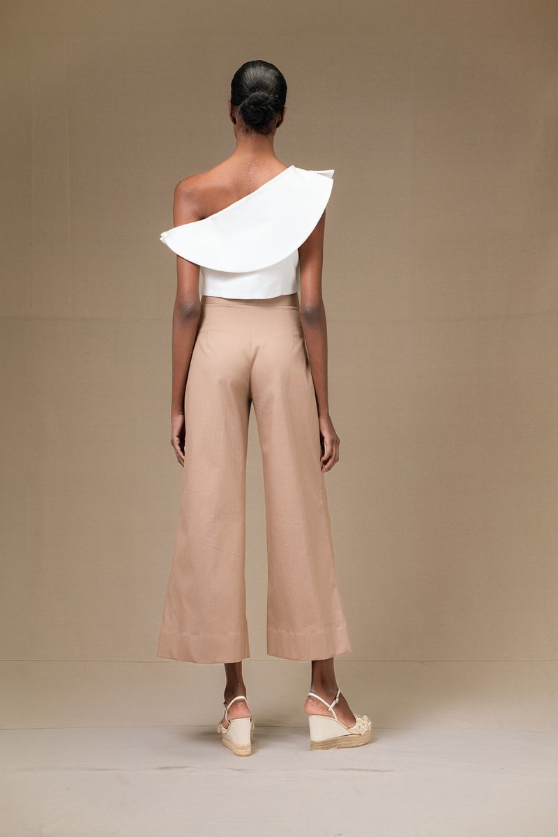 Ivory ROSAVE crop top by ANA + MARIA, shown on a model, featuring a fitted design and stylish neckline.
