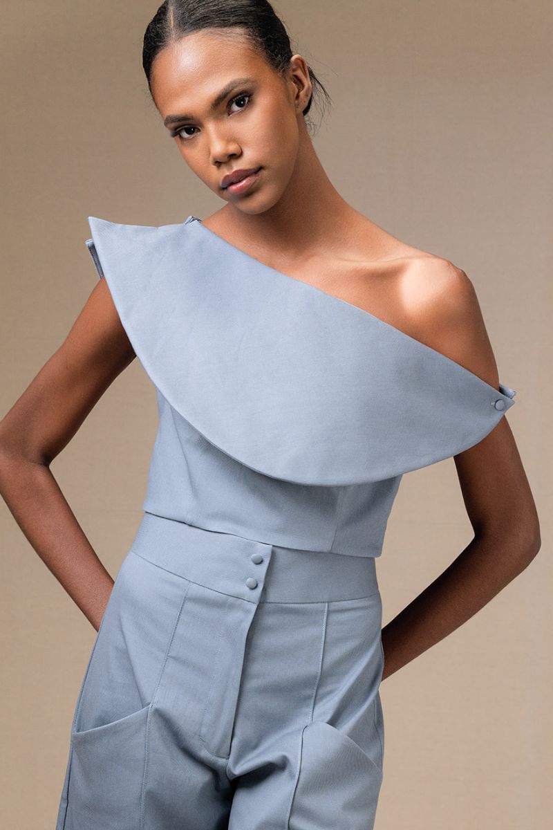 ANA + MARIA Rosave crop top in tempest color, featuring a stylish fitted design, shown on a model with a casual background.