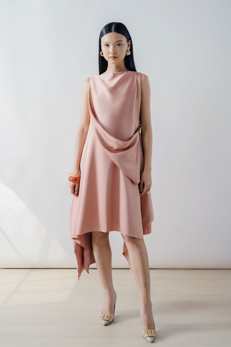 Rose pink draped asymmetric sleeveless midi dress by DOC BAN, featuring elegant flowy fabric and modern design.