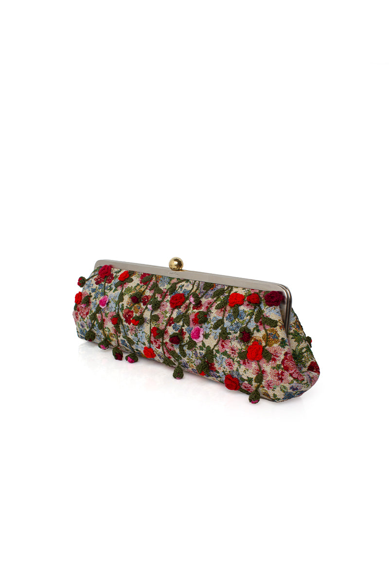 Multicolor Roses Le Long clutch by Sarah's Bag featuring vibrant rose patterns and a sleek, elegant design.