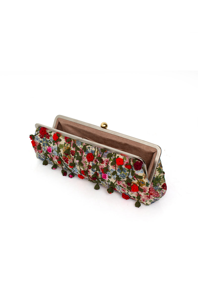 Multicolor Roses Le Long clutch bag by Sarah's Bag featuring a floral design with vibrant roses and a sleek, elegant style.