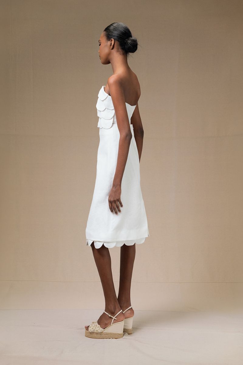 Ivory Ana + Maria Rossette midi skirt displayed on a model, featuring a flowy, elegant design perfect for stylish outfits.